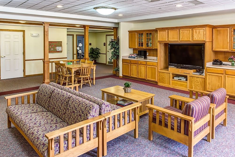 Spacious community room with big screen TV at Prairie Hills Tipton in Tipton, Iowa.