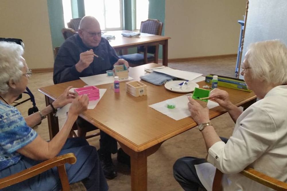 Residents painting crafts together at Prairie Meadows Senior Living in Kasson, Minnesota