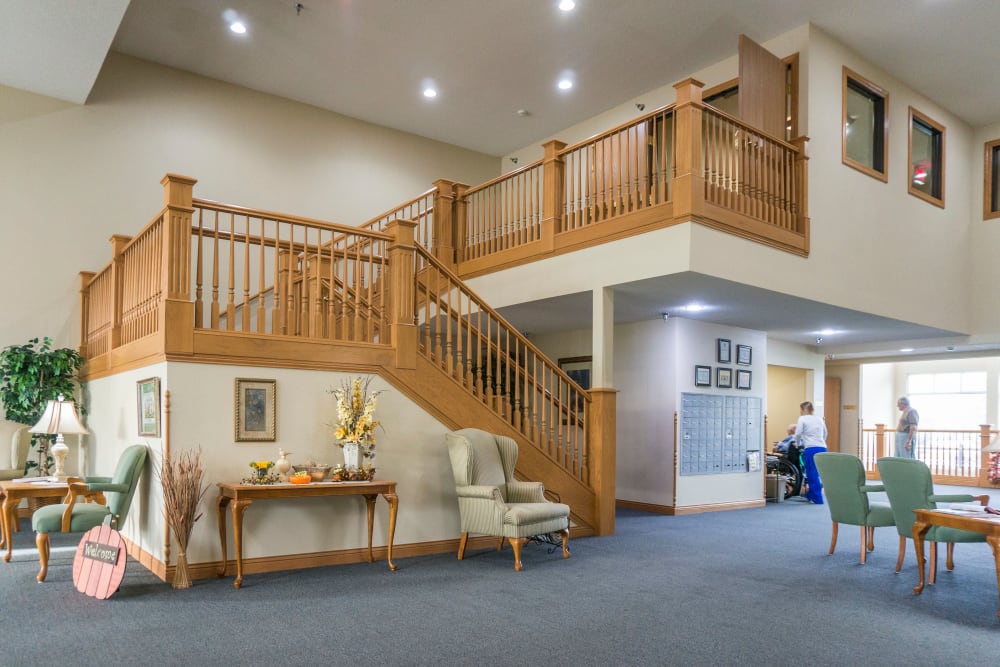 Main lobby with grand staircase at Prairie Meadows Senior Living in Kasson, Minnesota