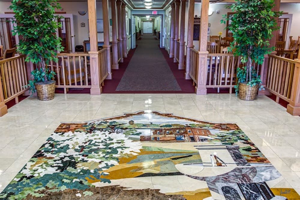 Main lobby with tile mosaic at Addington Place of Des Moines in Des Moines, Iowa.