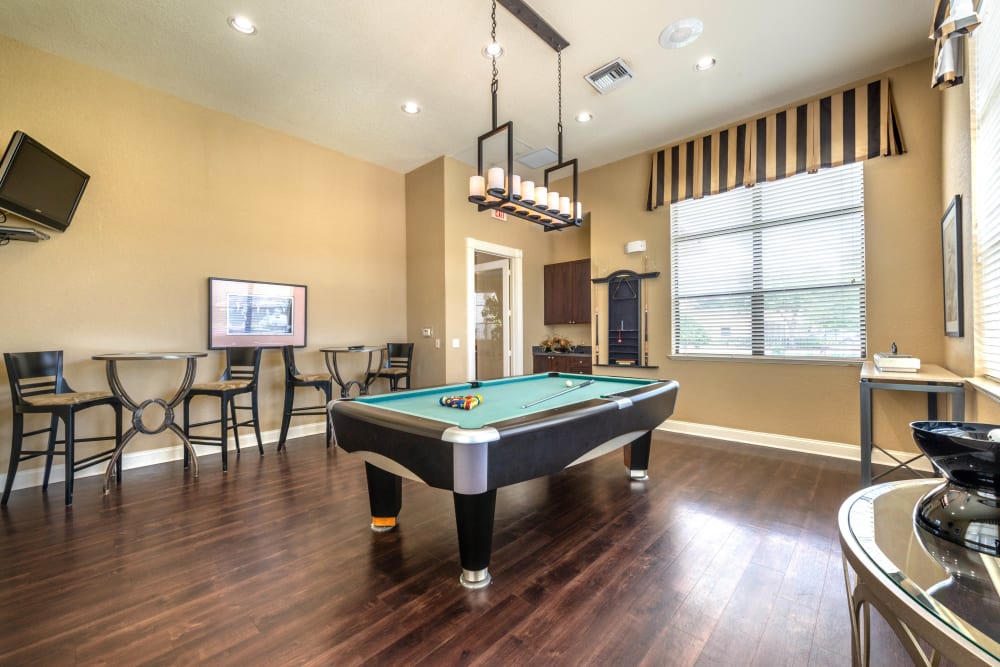 Game room with billiards in the clubhouse at Mirador & Stovall at River City in Jacksonville, Florida