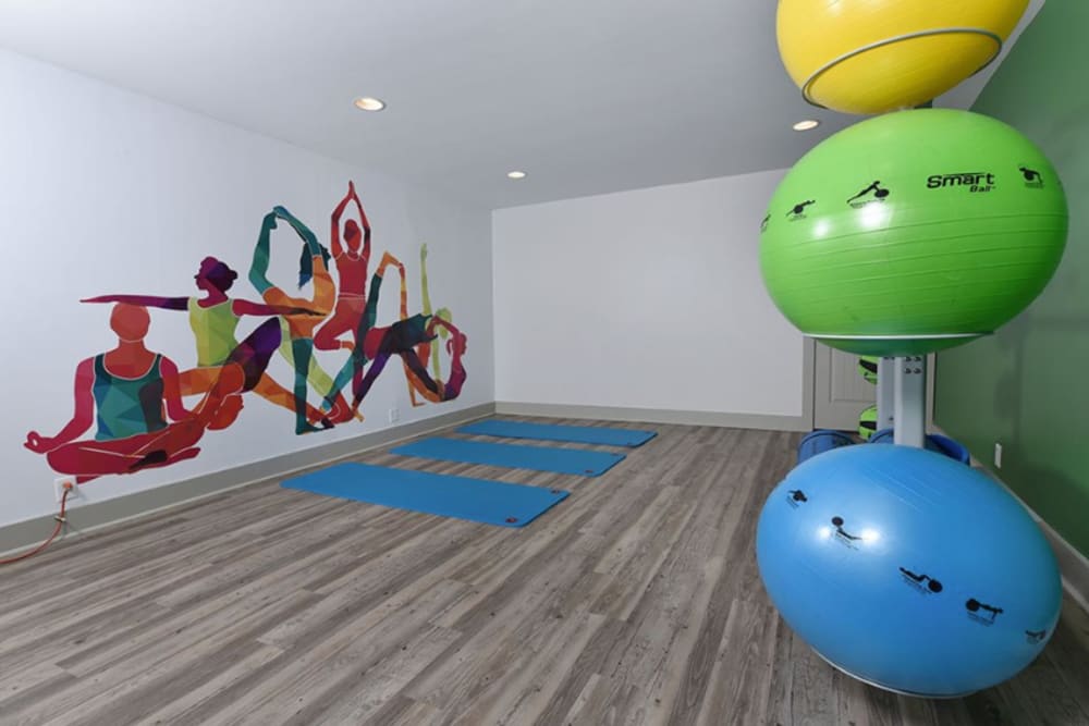 The fitness center at The Highland on Briley in Nashville, Tennessee offers a movement studio featuring a yoga themed mural