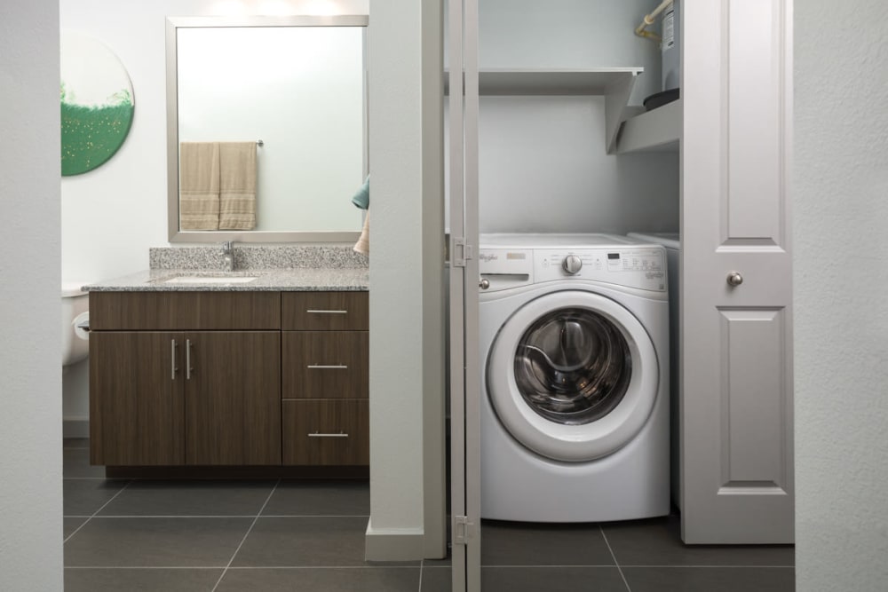 In-unit washer and dryer in a model apartment at Lux on Main in Carrollton, Texas