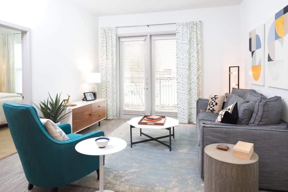 Comfortably decorated living area in a model home at Lux on Main in Carrollton, Texas