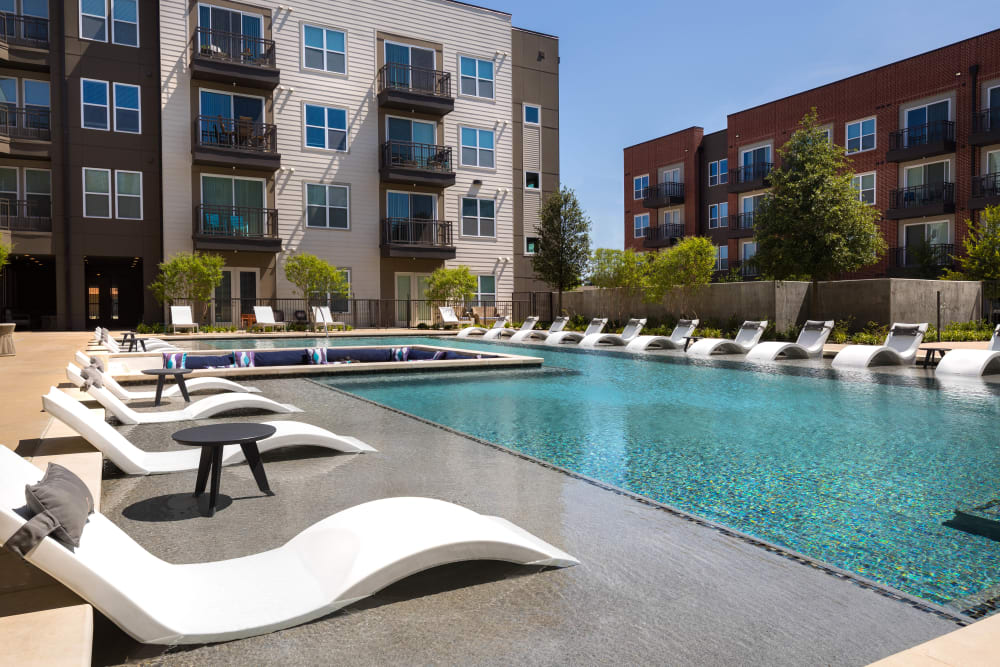 Lounge chairs in the pool's sun deck at Lux on Main in Carrollton, Texas
