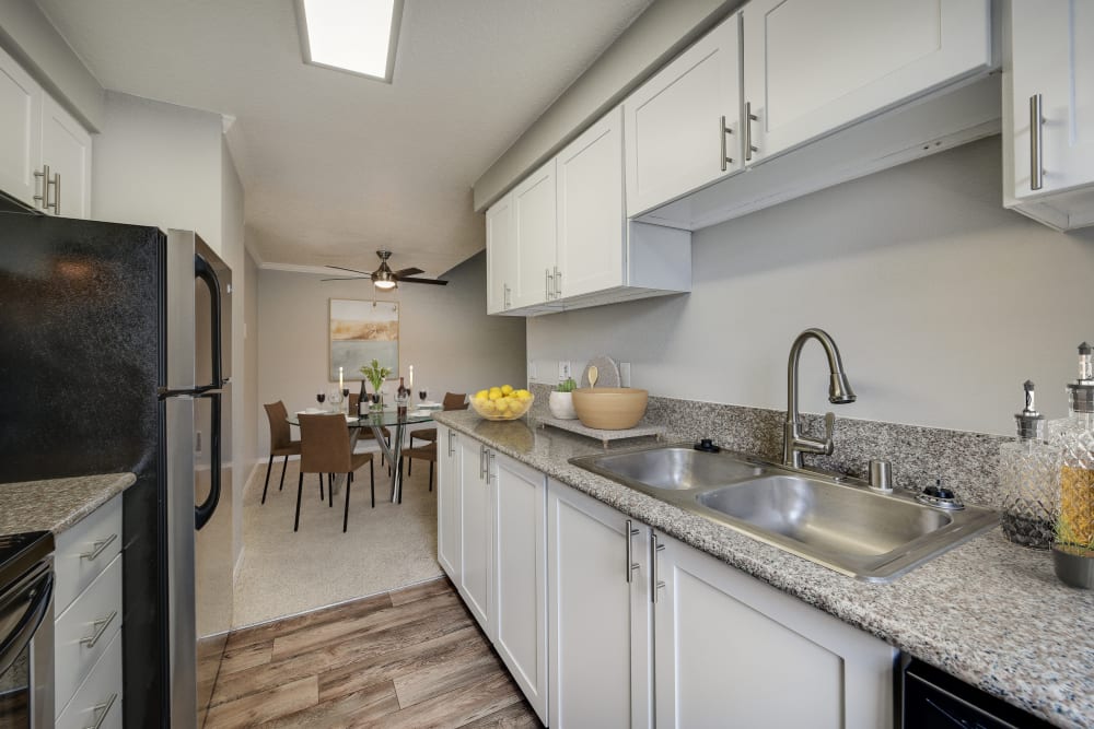 Modern , newly renovated white kitchen with stainless steel appliances at Walnut Grove Landing Apartments in Vancouver, WA
