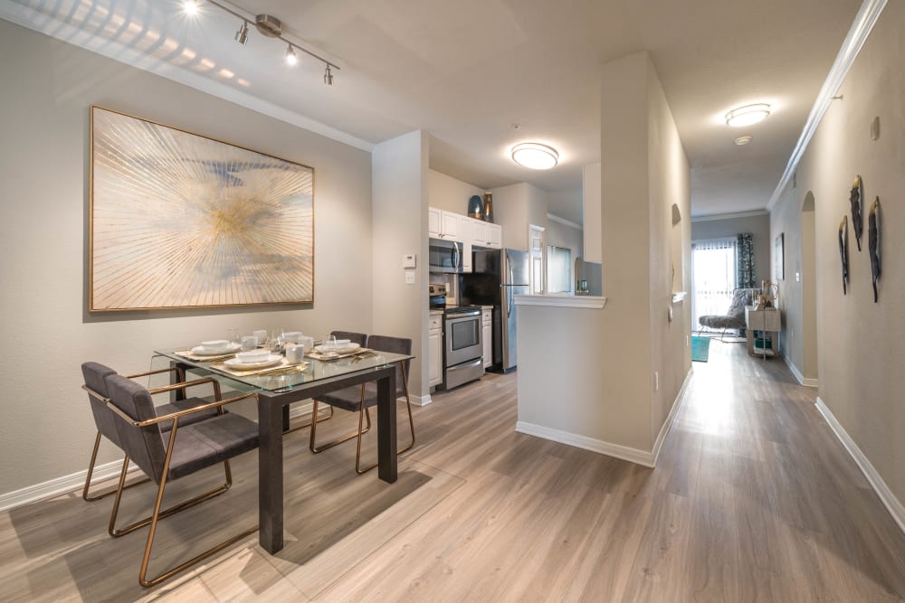 Beautiful hardwood flooring throughout the living areas of a model home at Olympus Town Center in Keller, Texas