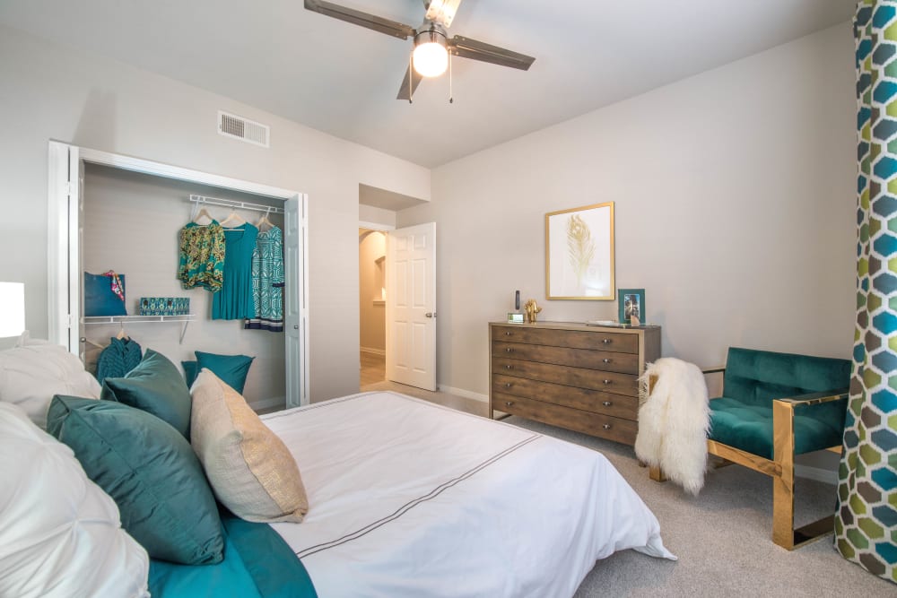 Plush carpeting and a large closet in the primary bedroom of a model home at Olympus Town Center in Keller, Texas