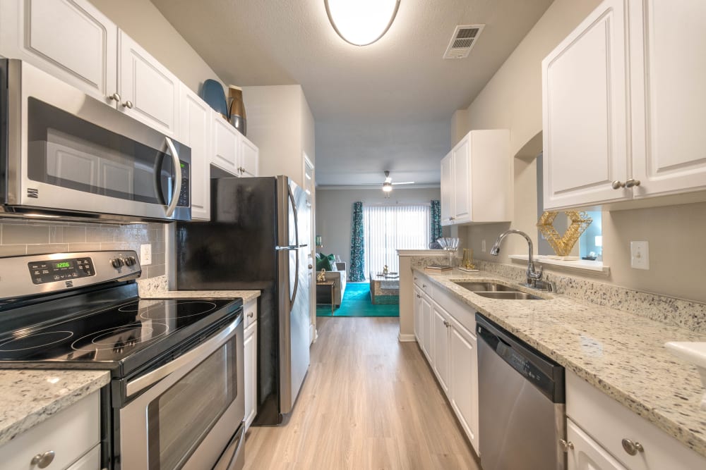 Gourmet kitchen with granite countertops in a model home at Olympus Town Center in Keller, Texas