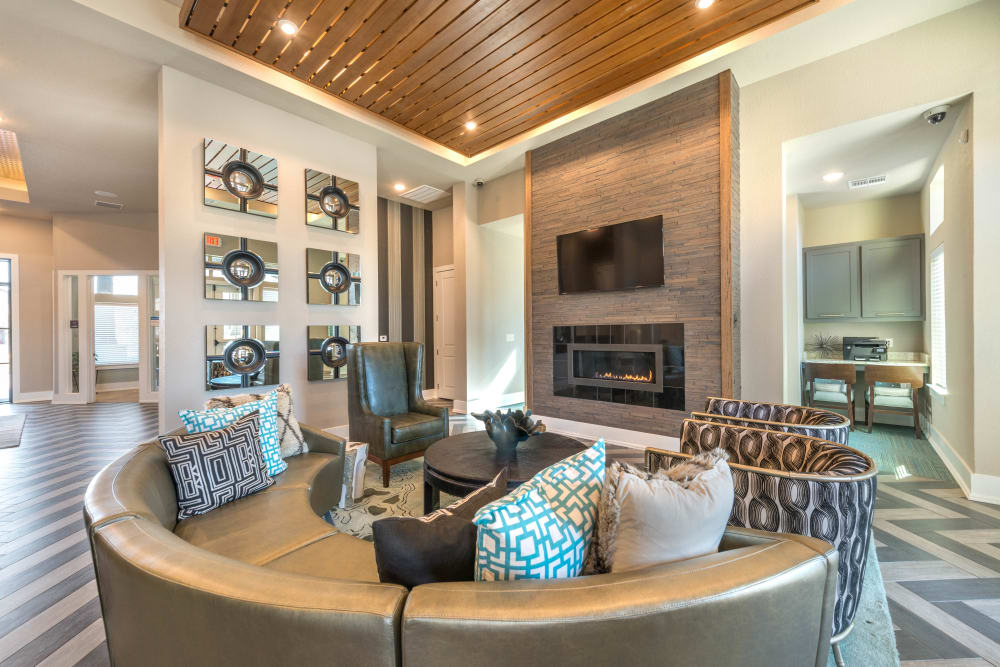 Lounge area in front of the fireplace in the clubhouse lounge at Olympus Waterford in Keller, Texas