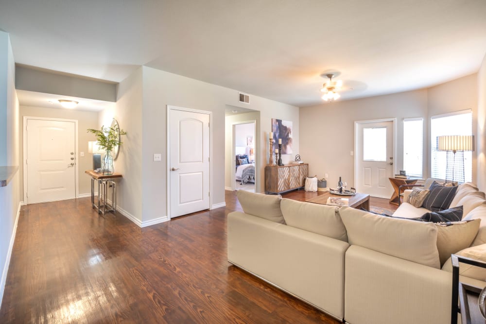 Beautiful hardwood flooring throughout the living areas in a model home at Olympus Willow Park in Willow Park, Texas