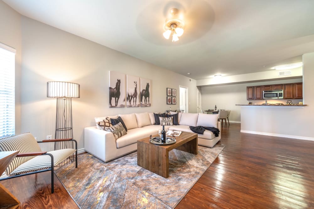 Beautiful hardwood floors in the living areas of a model home at Olympus Willow Park in Willow Park, Texas