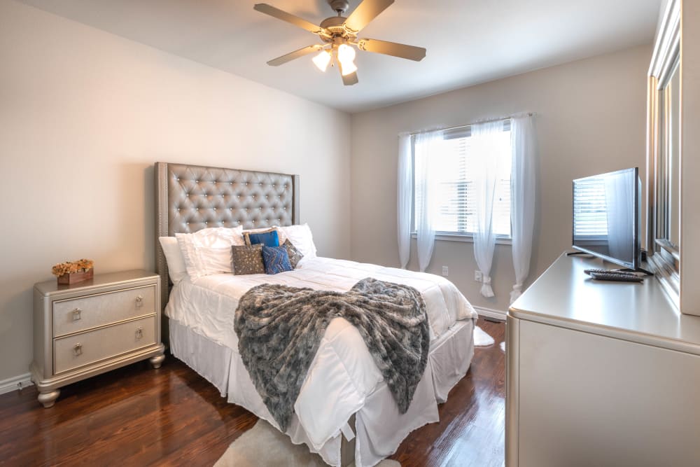 Ceiling fan and draped windows in a model home's bedroom at Olympus Willow Park in Willow Park, Texas