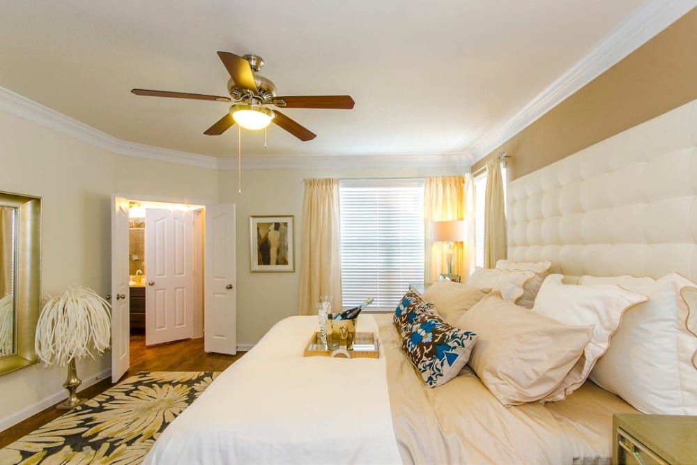 Beautifully furnished primary bedroom in a model home at Olympus Woodbridge in Sachse, Texas