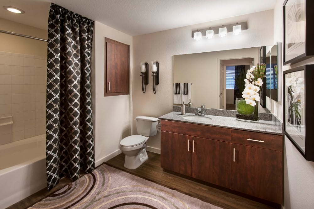 Spacious bathroom with a tiled shower in a model home at Redstone at SanTan Village in Gilbert, Arizona