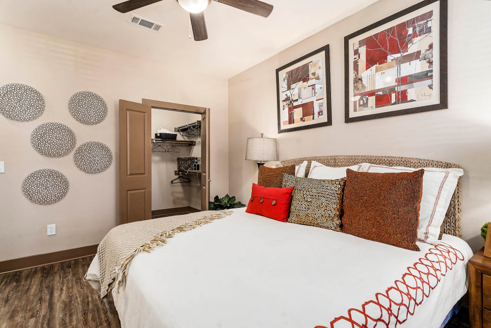 Well-furnished primary bedroom with a ceiling fan in a model home at Sedona Ranch in Odessa, Texas