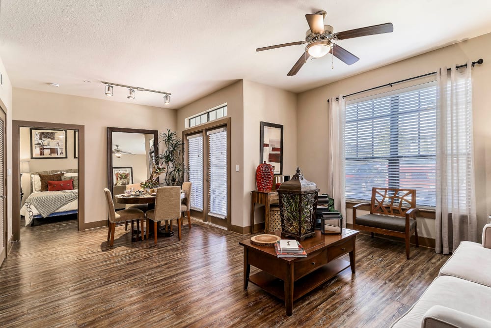 Ceiling fan and hardwood floors in the living area of a model apartment at Sedona Ranch in Odessa, Texas