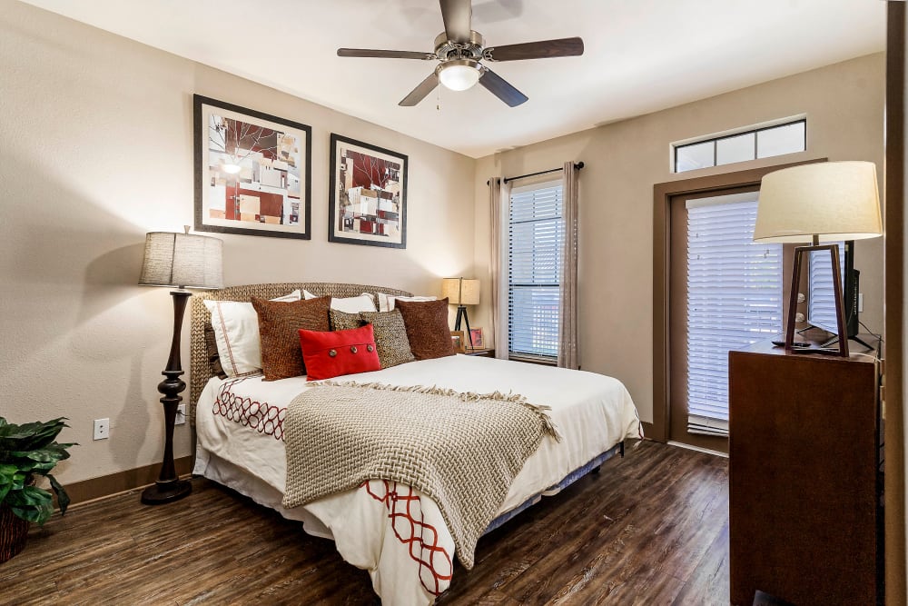 Ceiling fan and beautiful hardwood flooring in a model home's bedroom at Sedona Ranch in Odessa, Texas