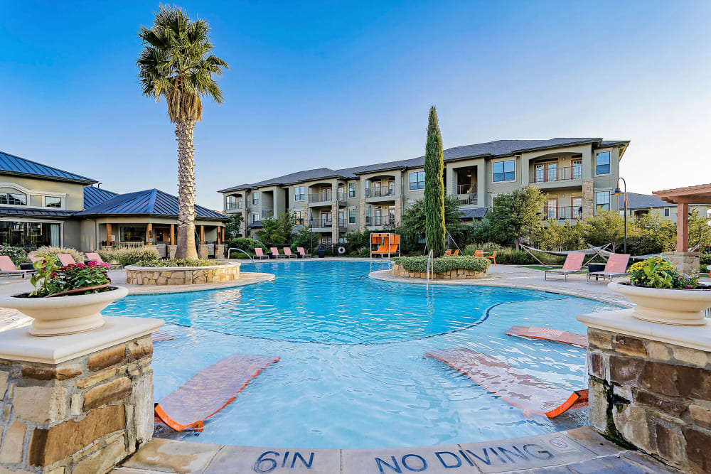 In-pool sun deck with lounge chairs at Sedona Ranch in Odessa, Texas