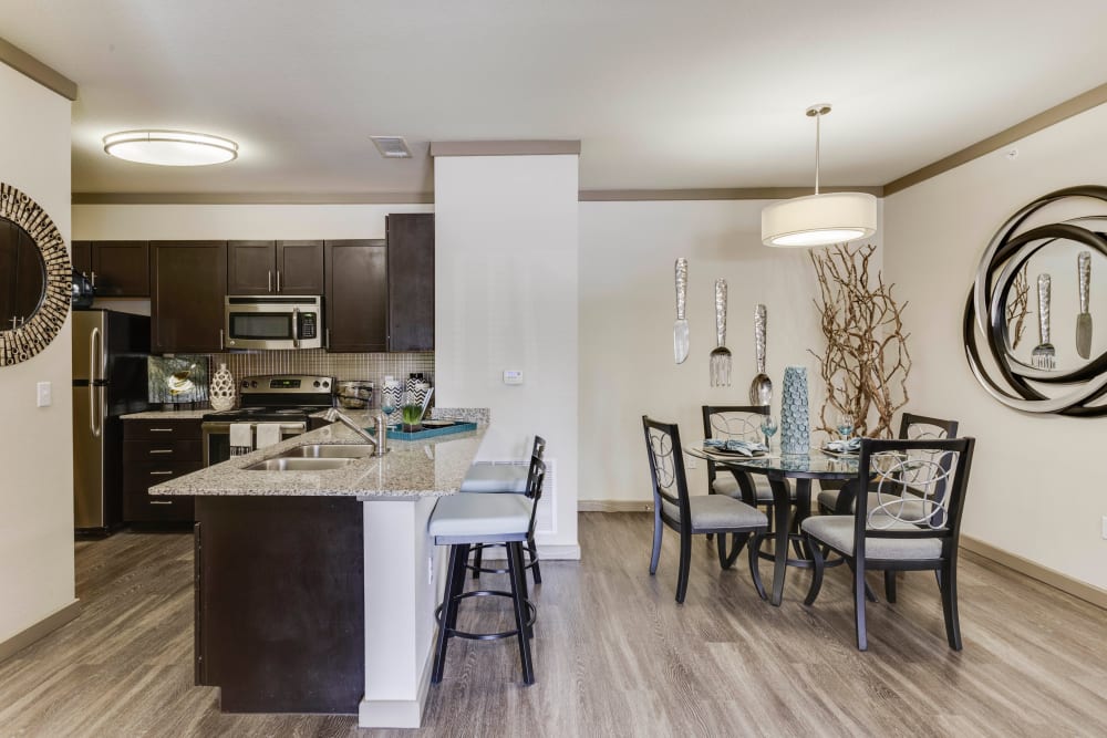 Dining area next the kitchen's breakfast bar in a model home at Tacara at Westover Hills in San Antonio, Texas