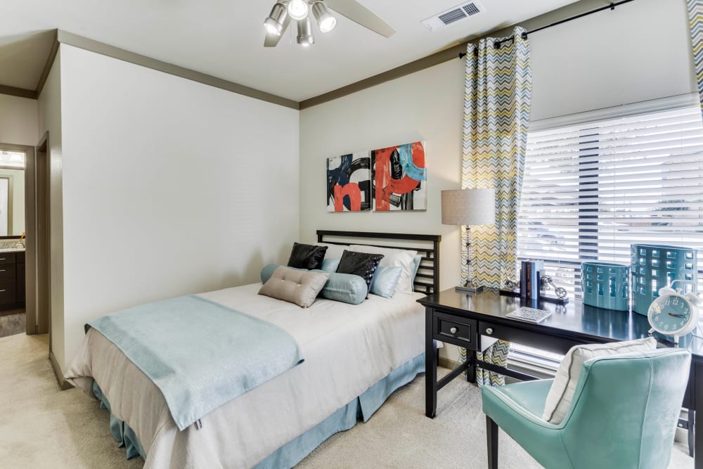 Ceiling fan and plush carpeting in a model home's primary bedroom at Tacara at Westover Hills in San Antonio, Texas