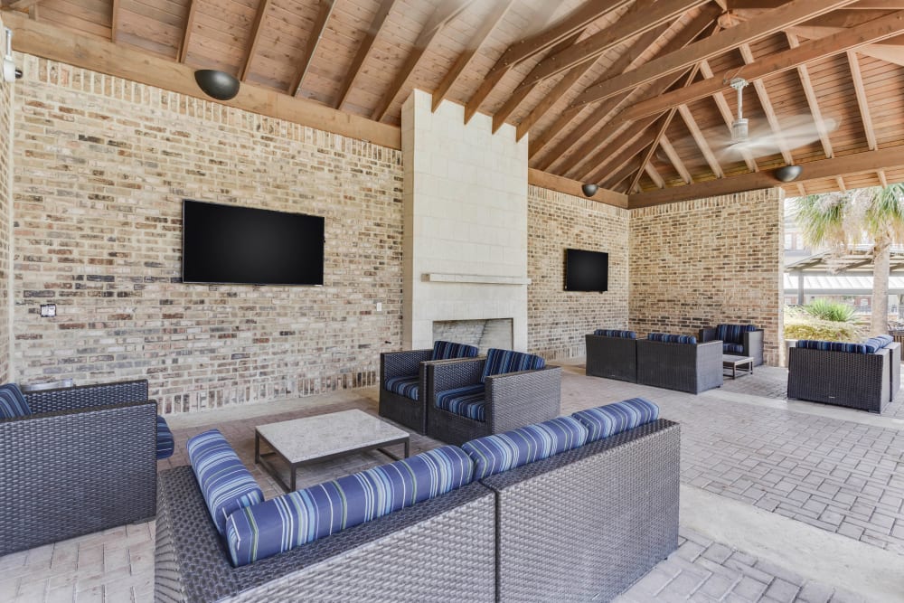Covered outdoor lounge with flatscreen TVs at Tacara at Westover Hills in San Antonio, Texas