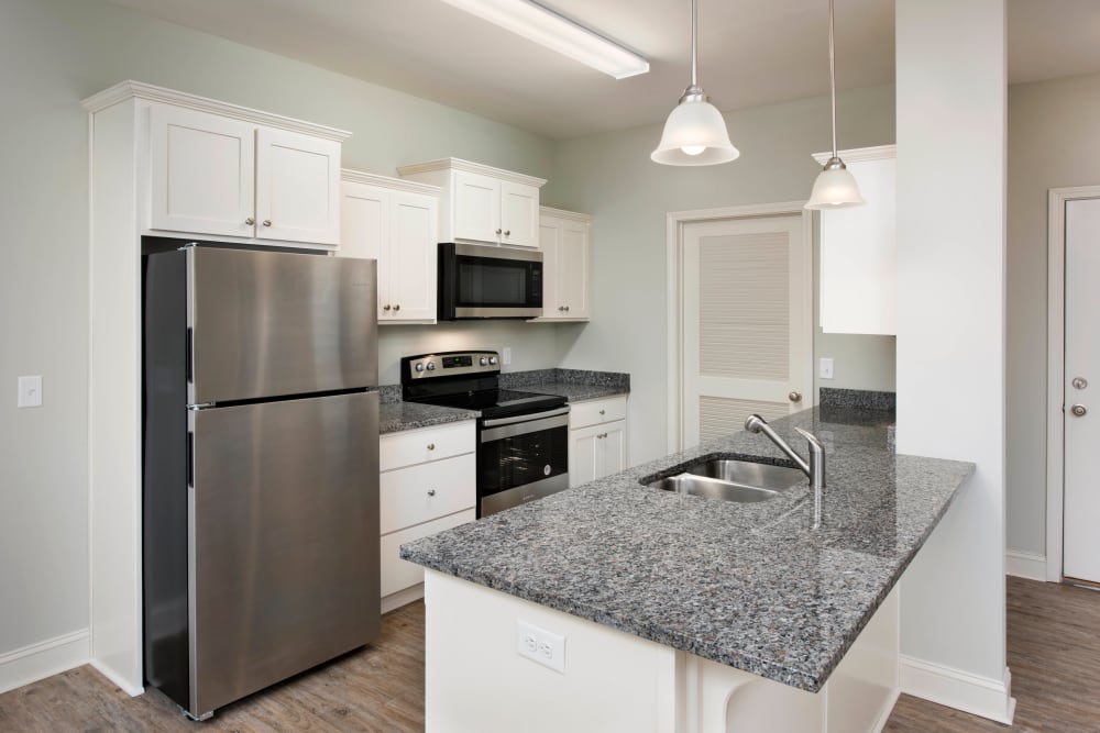 Model home's kitchen with stainless-steel appliances at The Enclave in Brunswick, Georgia
