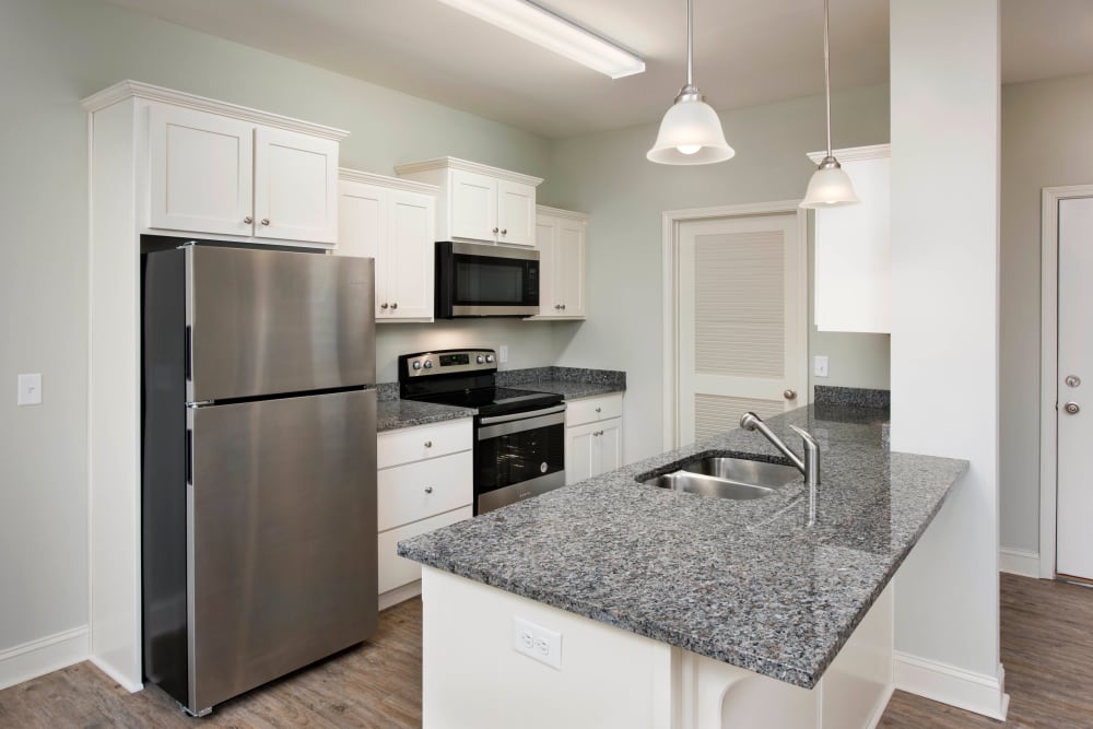 Granite countertops in a model home's kitchen at The Enclave in Brunswick, Georgia