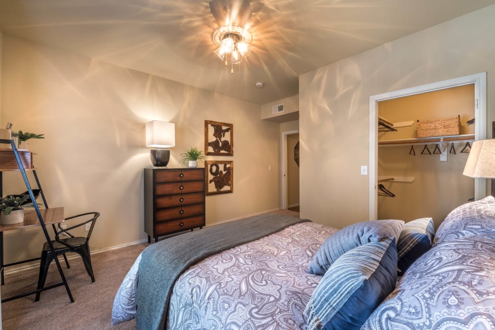 Walk-in closet and a ceiling fan in a model home's master bedroom at The Ranch at Shadow Lake in Houston, Texas