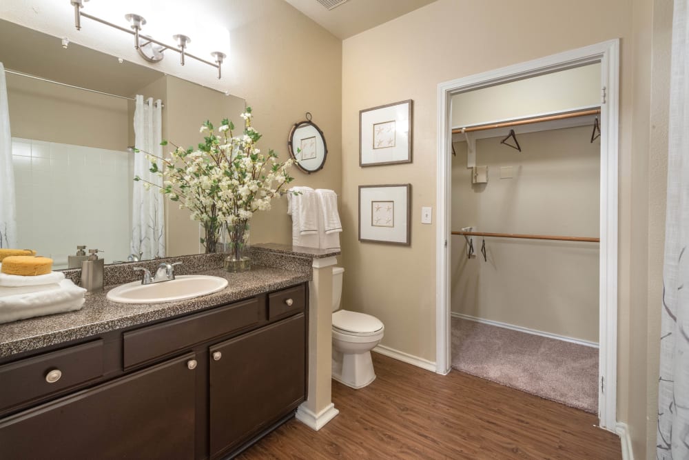 Granite countertop and plenty of storage space in a model home's bathroom at The Ranch at Shadow Lake in Houston, Texas