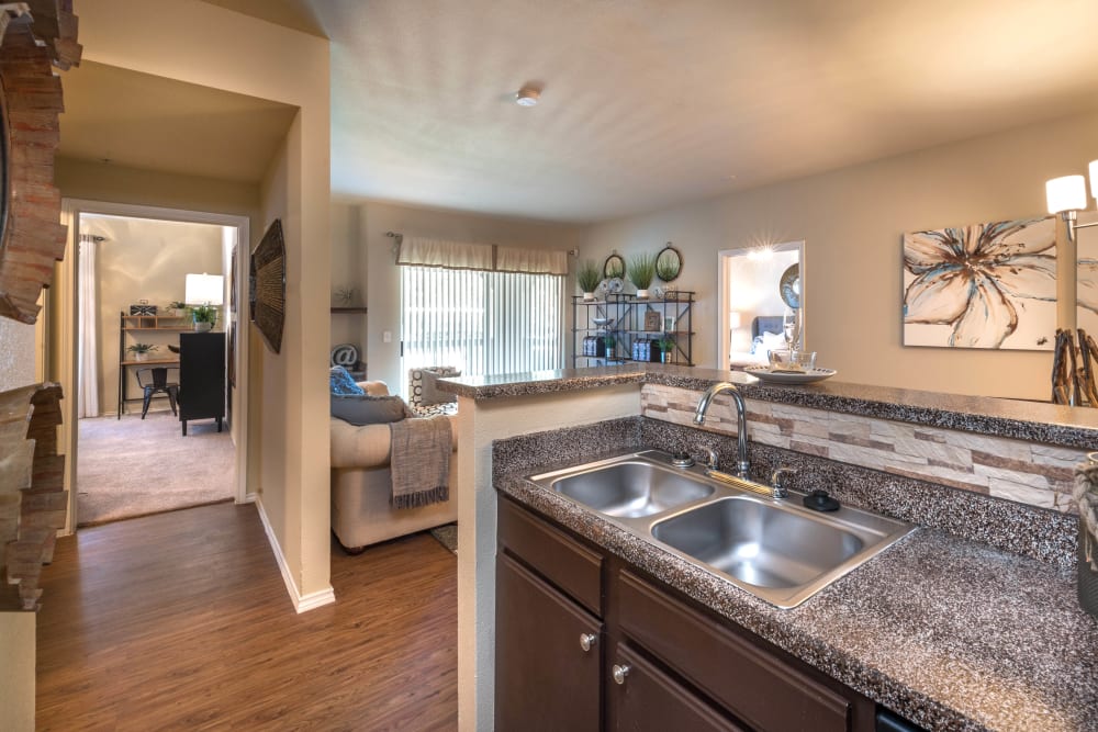 Beautiful granite countertops in the open-concept kitchen of a model home at The Ranch at Shadow Lake in Houston, Texas