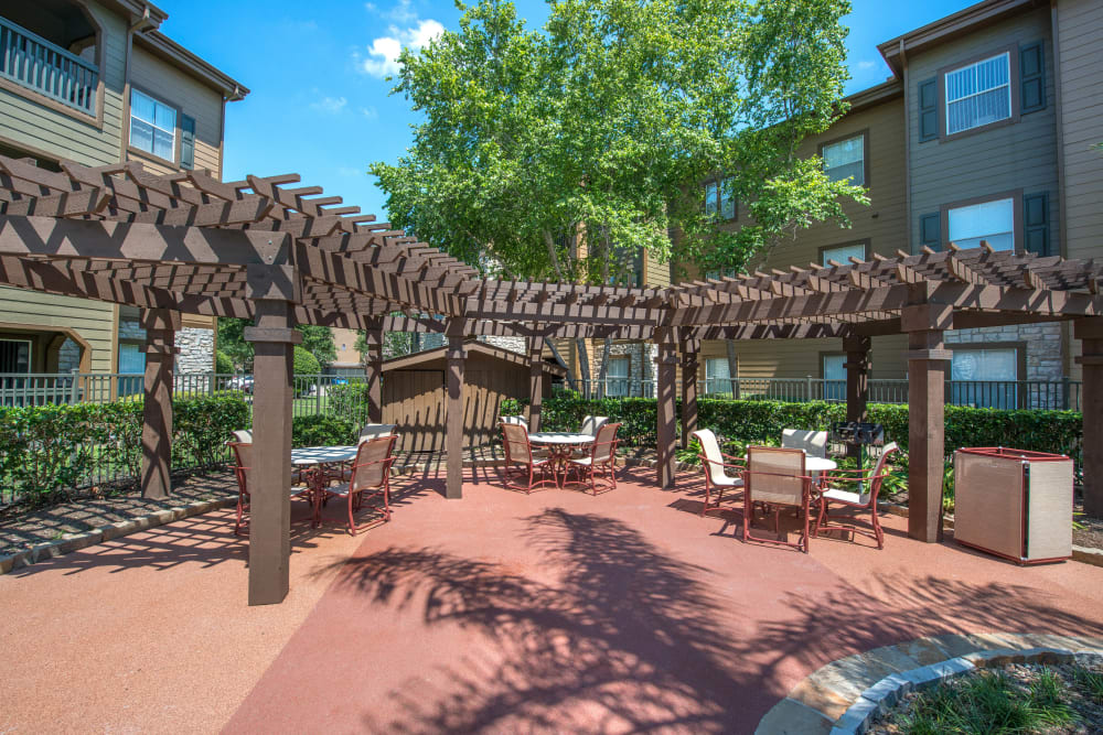 Expansive pergola providing some shade at one of the outdoor lounge areas at The Ranch at Shadow Lake in Houston, Texas