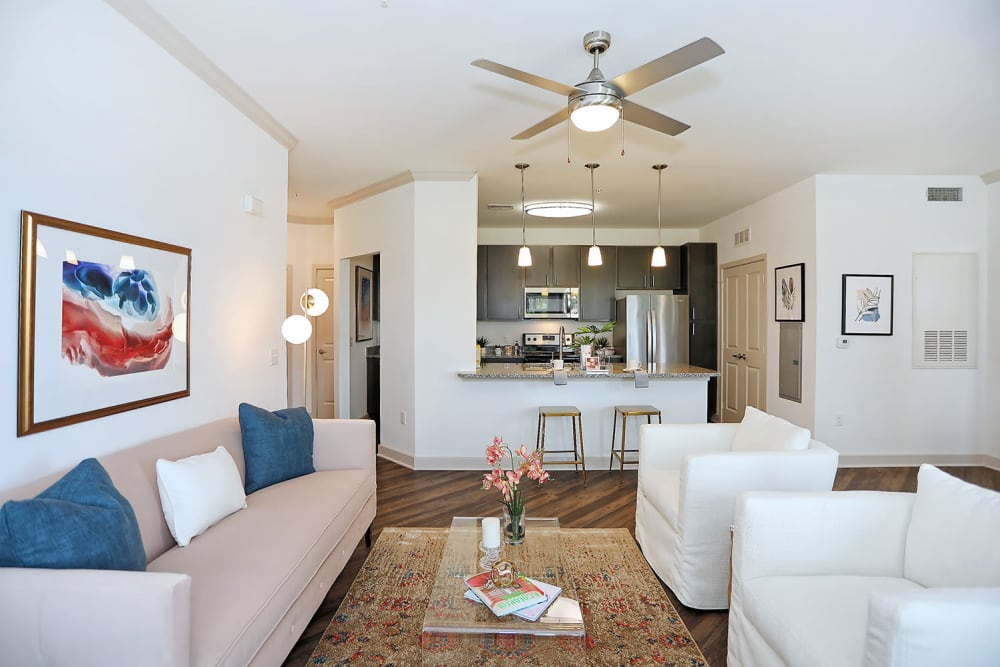Well-furnished living area with a ceiling fan in a model apartment at The Slate in Savannah, Georgia