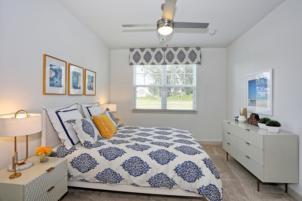 Plush carpeting and a ceiling fan in a model home's bedroom at The Slate in Savannah, Georgia