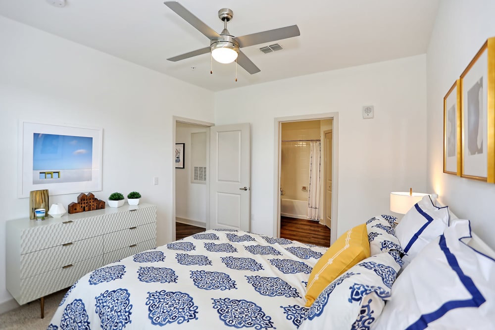 En suite bathroom and a ceiling fan in a model home's bedroom at The Slate in Savannah, Georgia