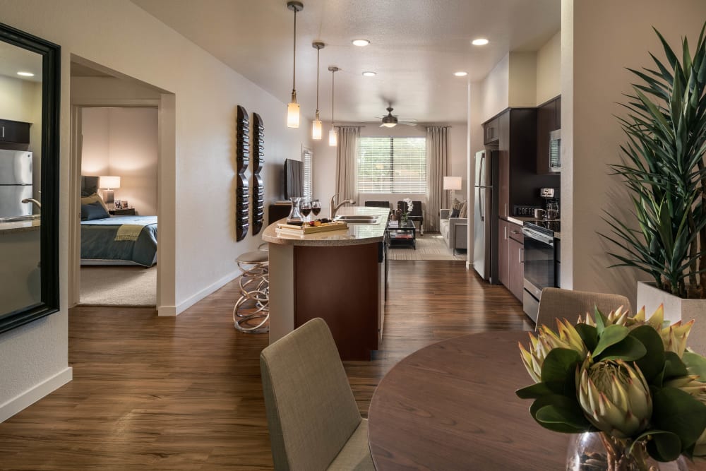 Spacious open-concept layout with beautiful hardwood flooring in a model home at Vistara at SanTan Village in Gilbert, Arizona