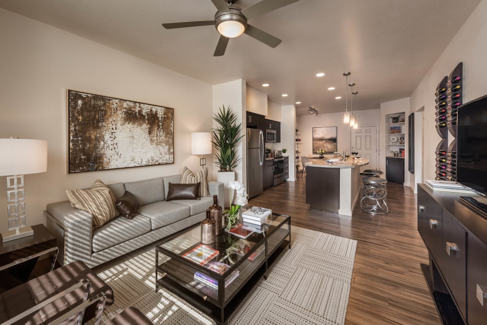 Well-furnished living space with a ceiling fan in a model home at Vistara at SanTan Village in Gilbert, Arizona