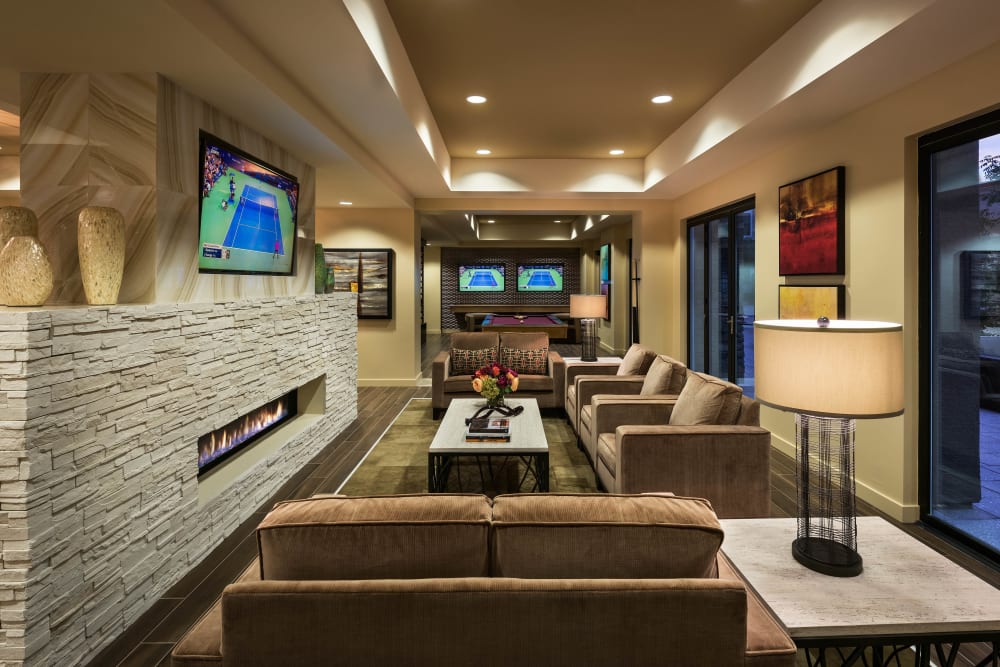 Fireplace and flatscreen TV in the clubhouse lounge at Vistara at SanTan Village in Gilbert, Arizona