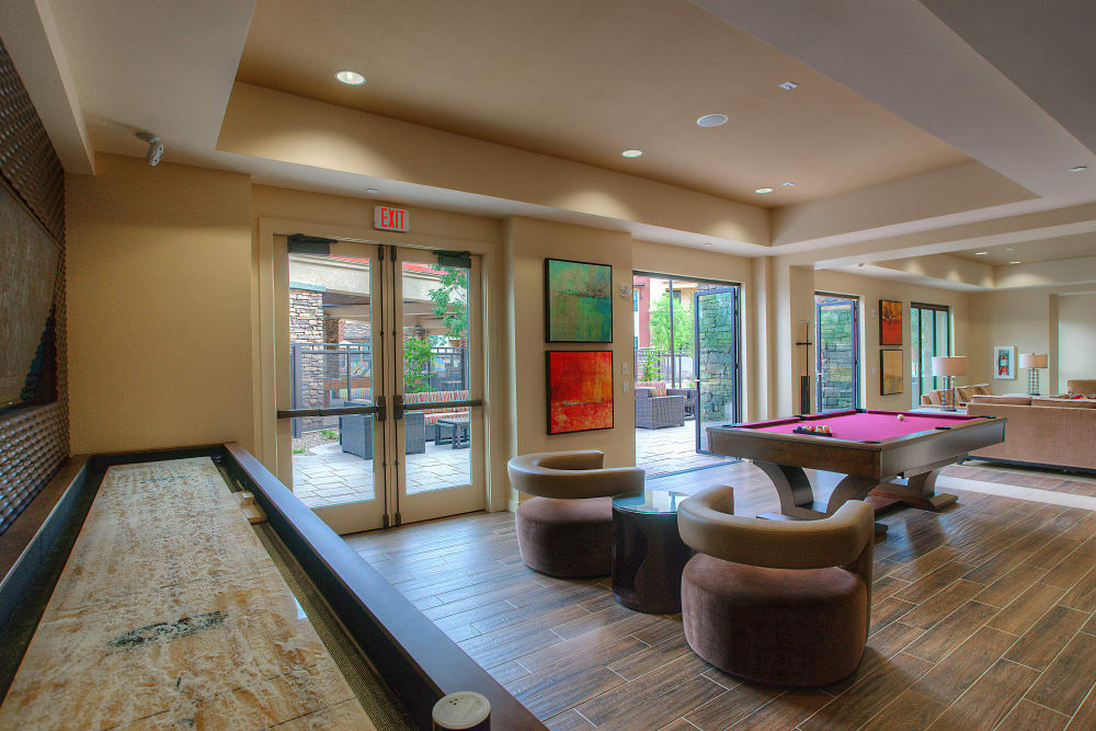 Billiards, tabletop shuffleboard, and more in the clubhouse game room at Vistara at SanTan Village in Gilbert, Arizona