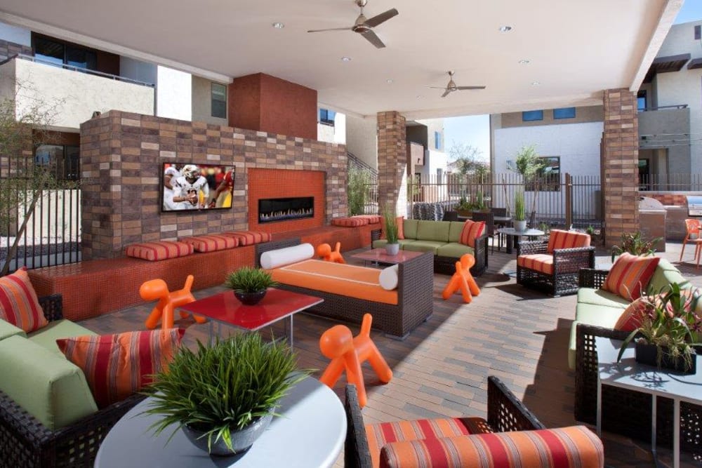 Expansive covered outdoor lounge area with ceiling fans and flatscreen TVs at Vive in Chandler, Arizona