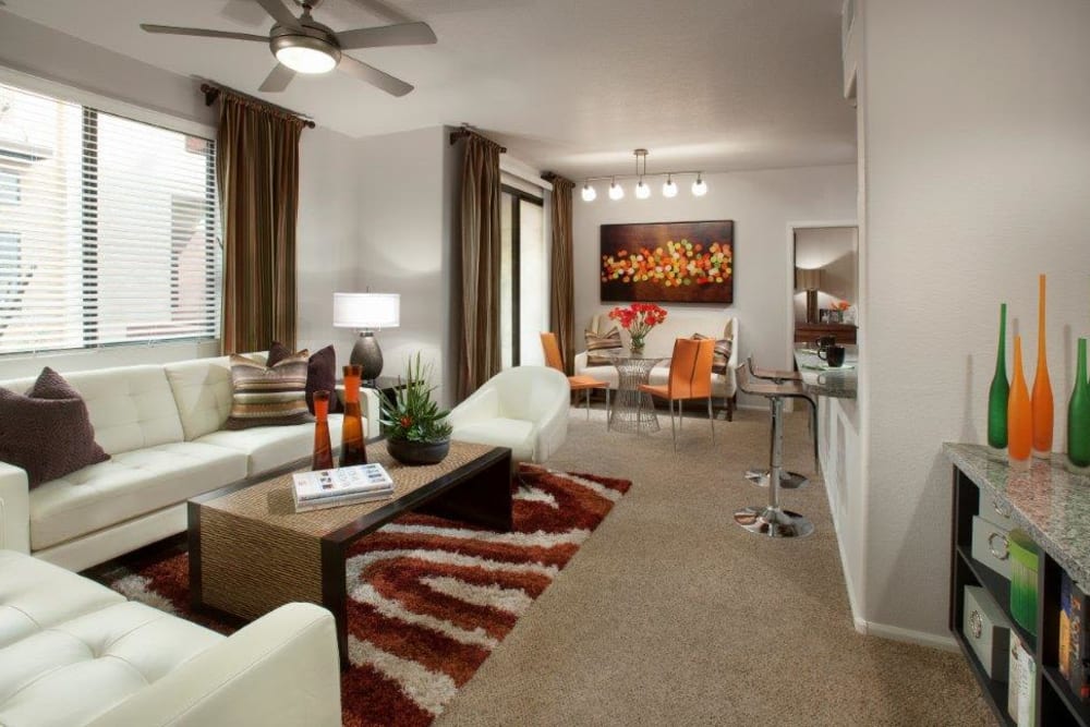 Modern furnishings and a ceiling fan in a model home's living area at Vive in Chandler, Arizona