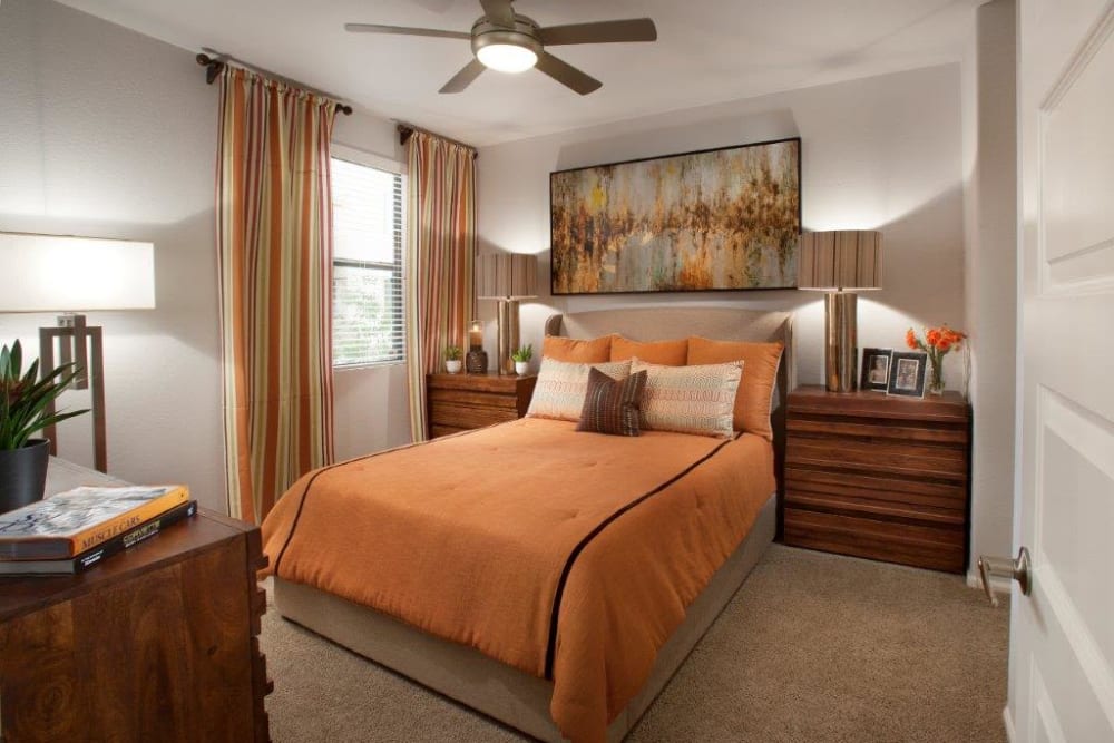 Ceiling fan and plush carpeting in a model home's primary bedroom at Vive in Chandler, Arizona