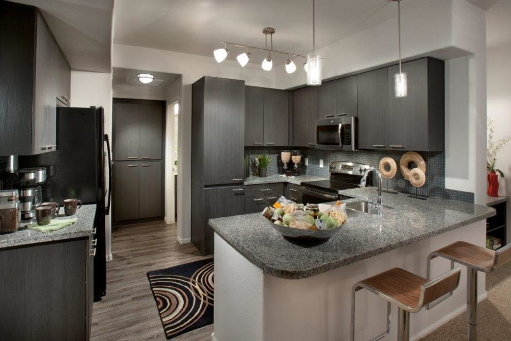 Beautiful open-concept gourmet kitchen with an island in a model home at Vive in Chandler, Arizona