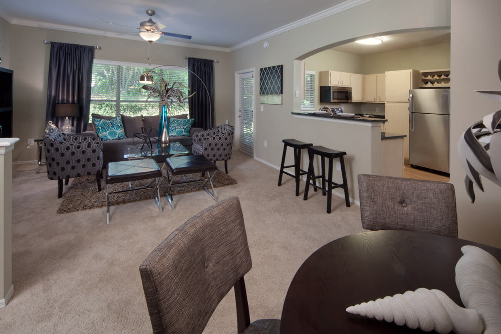 Open-concept model home with plush carpeting throughout the living areas at Wimberly at Deerwood in Jacksonville, Florida