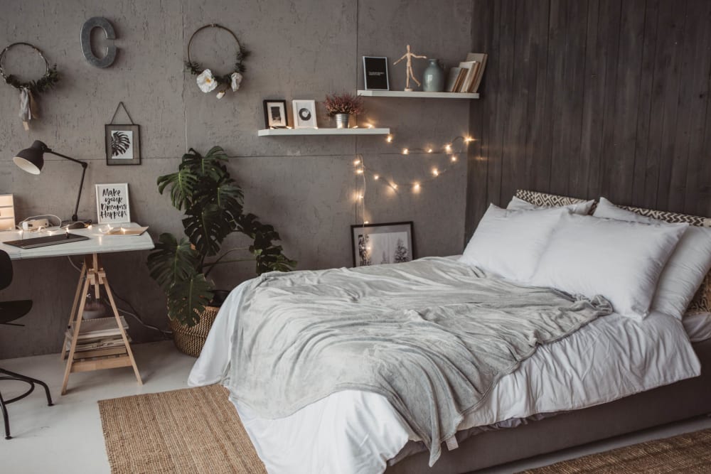Well-furnished bedroom in a model apartment at Olympus Court Apartments in Bakersfield, California