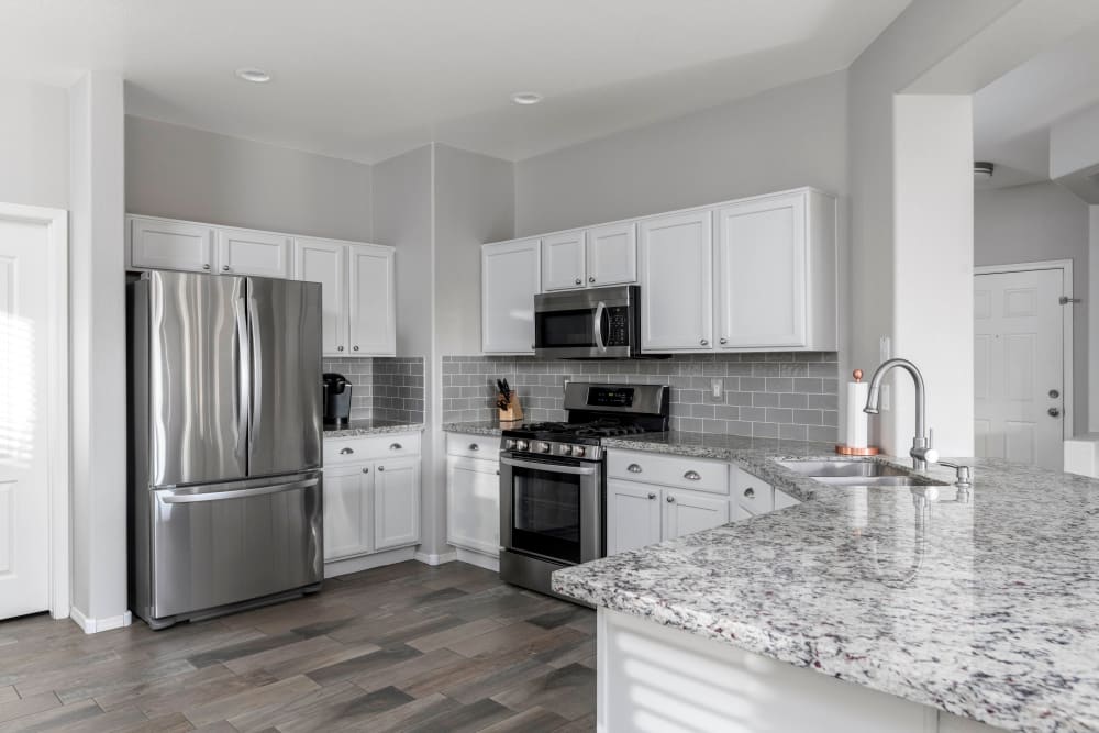 Granite countertops in a model apartment's kitchen at Olympus Court Apartments in Bakersfield, California