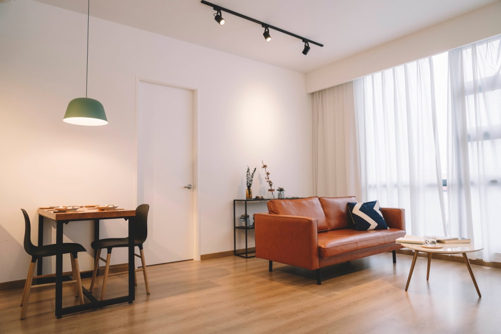 Open-concept model apartment with hardwood floors at Olympus Court Apartments in Bakersfield, California