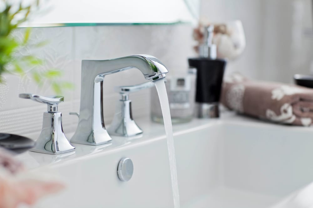 Modern fixtures in a model apartment's bathroom at Olympus Court Apartments in Bakersfield, California