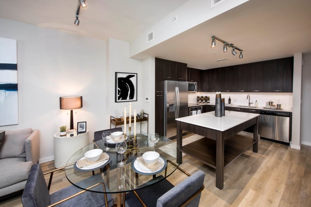 Open-concept dining and kitchen areas in a model home at Olympus Harbour Island in Tampa, Florida