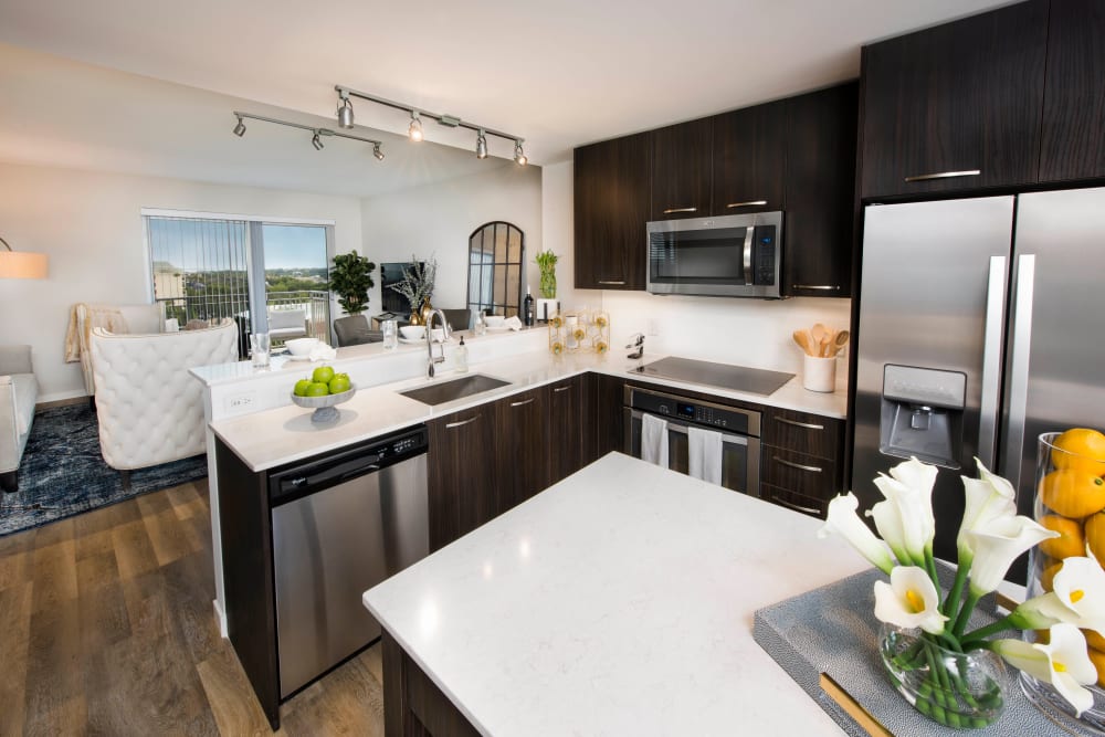 Gorgeous quartz countertops and an island in a model luxury home's gourmet kitchen at Olympus Harbour Island in Tampa, Florida